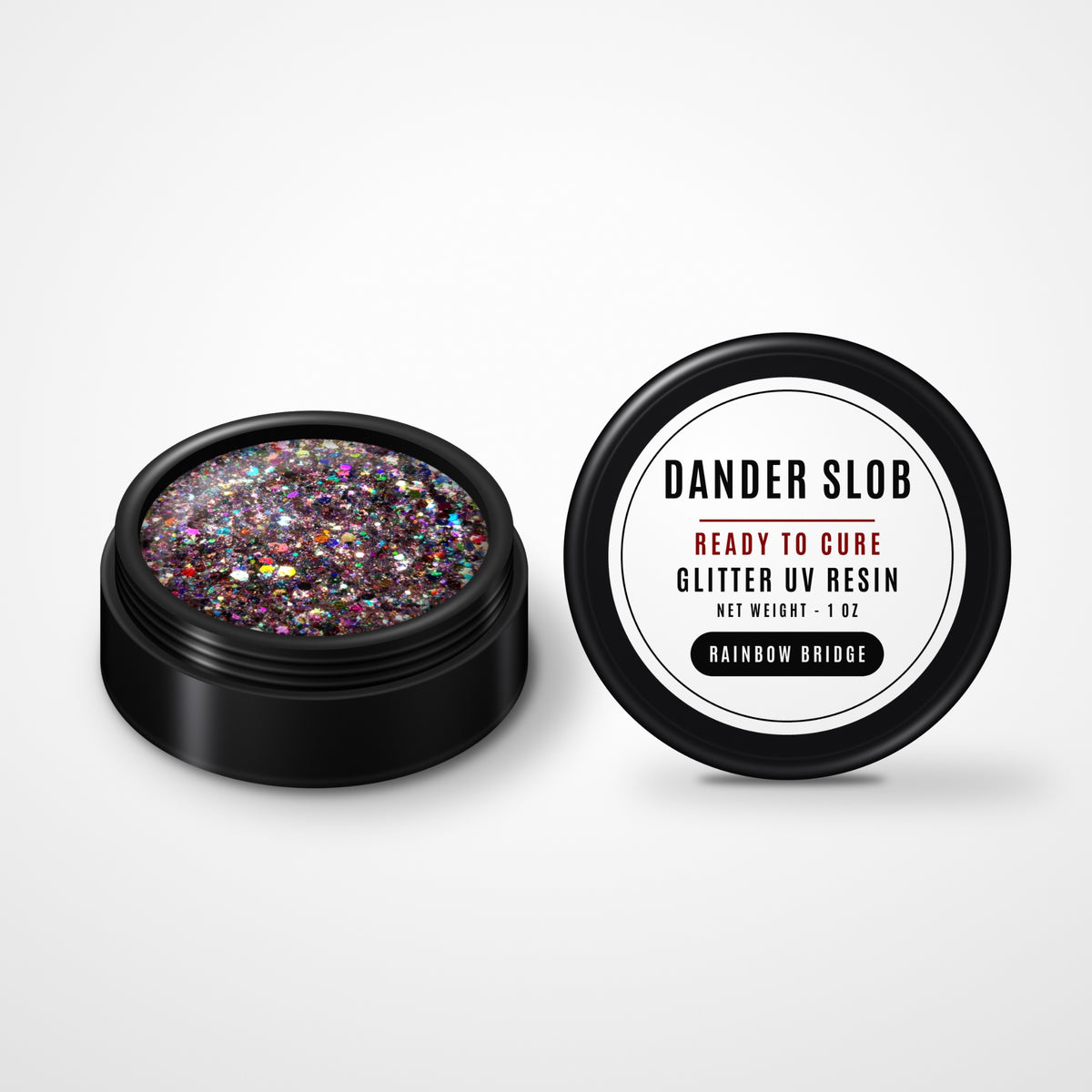 Dander Slob Rainbow Bridge glitter UV resin in an open black 1 oz jar with its labeled lid facing forward.